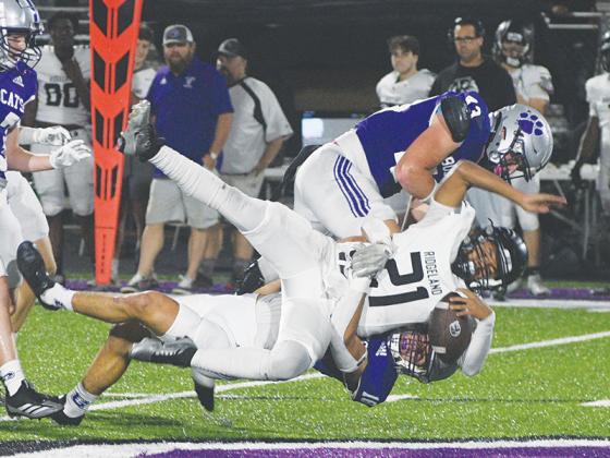 Gilmer senior linebacker Memphis Lewallen (18) takes down Ridgeland’s Cornell Watkins as teammate Douglas Callihan (43) lands a hit for good measure.