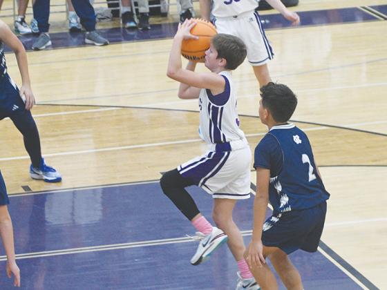 Seventh-grade Bobcat Reece Bramlett (above) shoots in the lane.