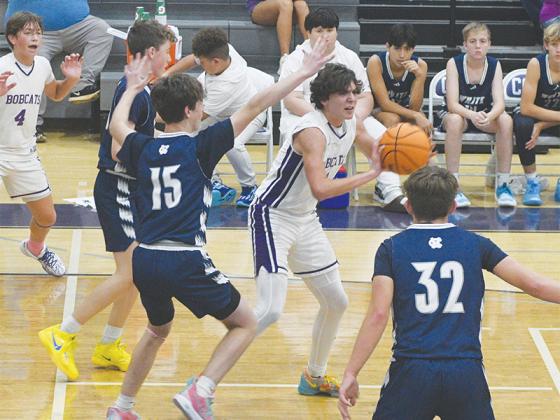 Slade Smith looks for an open teammate in the eighth-grade game.