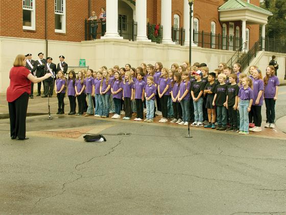 The Ellijay Elementary Chorus, under the direction of Katy Mayfield, warms up the crowd before the Veterans Day parade begins on Monday. They also performed during the ceremony, as did the Gilmer High School Chorus with Camden Pruitt directing.