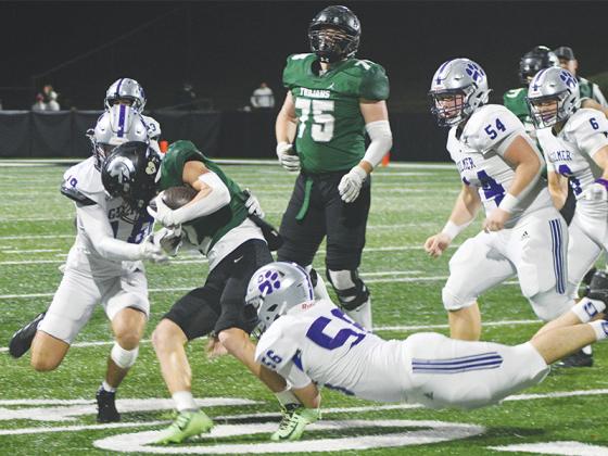 Gilmer seniors Memphis Lewallen (18) and Jake Hice (56) team up for a tackle last Friday in the first round of the state playoffs versus North Hall.