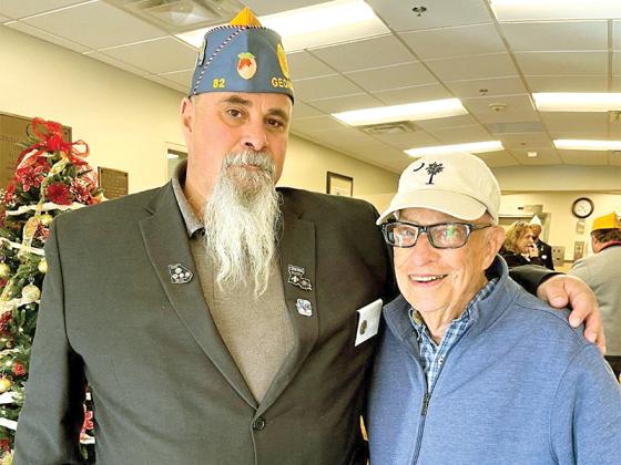 Brian Shedd of American Legion Post 82 in Ellijay recently visited with a former publisher of the Dalton Daily Citizen, George Clarke, of the Georgia War Veterans Nursing Home in Augusta. Shedd and Legion members across Georgia visited dozens of veterans in the pre-Christmas trip, and he sought out Clarke at the request of friends Mark and Teresa Millican. Clarke is wearing a hat with the South Carolina state symbol given him by the couple; his early years as a newspaperman were in the Charleston area. 