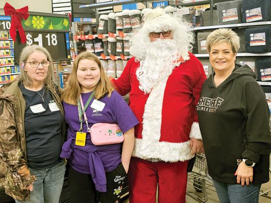 Kenzli and her grandmother take part in Shop with a Hero beside Santa Claus himself and Melissa Waddell of the sheriff’s office. (Contributed photos)