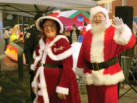 Santa and Ms. Claus make their way from the Santa House to the courthouse veranda to light the Christmas tree on the square. A vast crowd helped by counting down from 10 to 1.