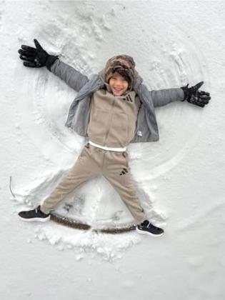 Wyatt, visiting his great grandma Sheila Davis, makes a snow angel.
