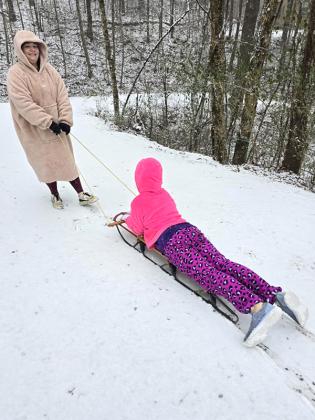 Hannah Denney, a 6th grader at Clear Creek Middle School, enjoys sledding with her mother, Ashlie Cappis.