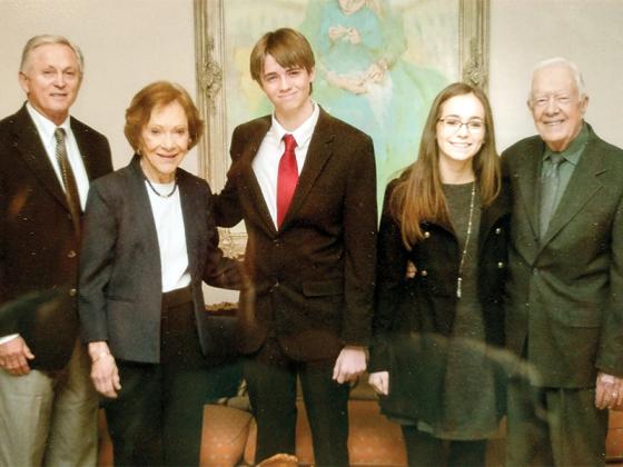 President Jimmy Carter and first lady Rosalynn Carter posed at a function with Wally Stover, left, and his grandkids Wally III and Erin.