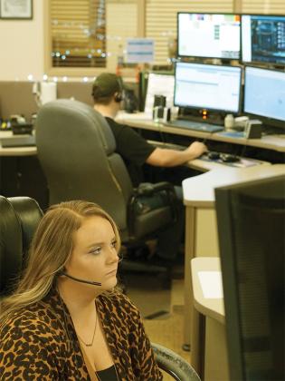 Breanna Akerson answers a call. She has worked at the 911 Center since 2021. (Lauren Sabia/Reporter)