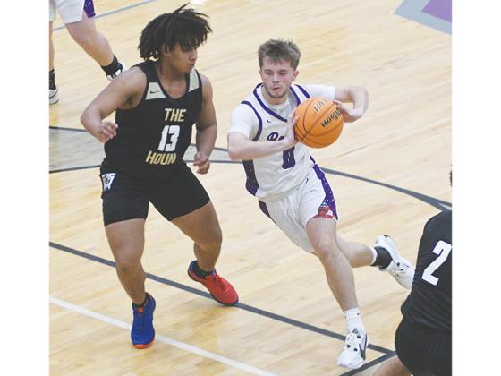 Gilmer junior Keegen Bryant penetrates the lane before passing to the perimeter. He scored 20 of his 22 points versus Murray County in the second half to help propel the Bobcats to a 64-55 win.