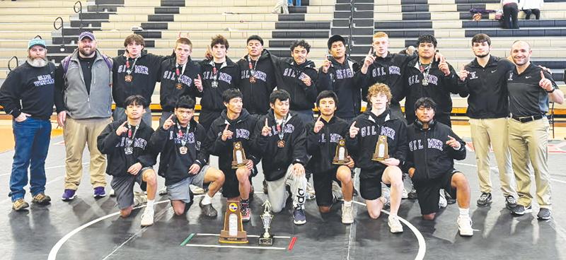 Gilmer High School wrestlers and coaches celebrate their Region 7-3A traditional championship last Saturday in LaFayette.