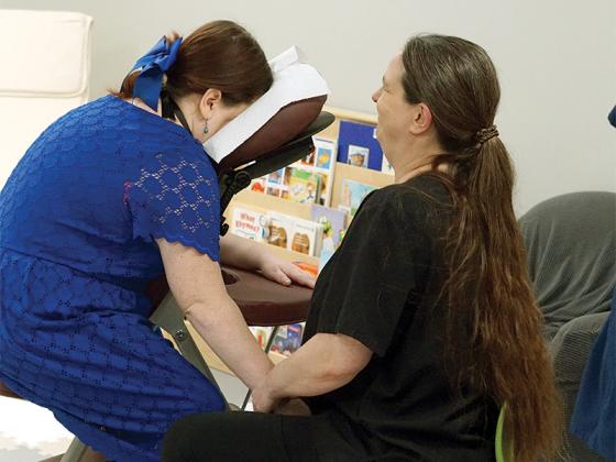 Massage therapist Anna Lisa Jones helps a caregiver relax. Heaven Sent Massage of Ellijay organized therapists from across the county to volunteer their services.
