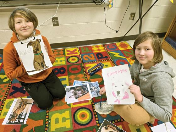 5th graders Fox and Leo Handley work on pet portraits.