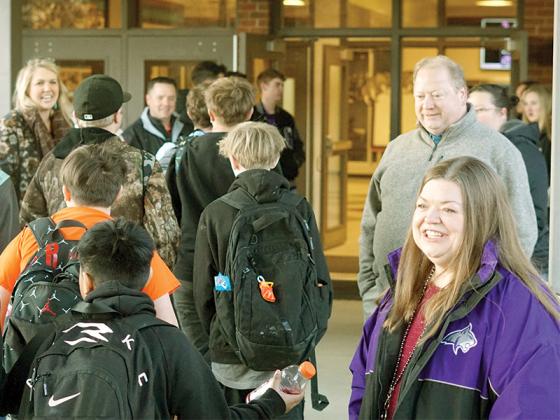 Federal Programs Director Lindey Patterson, right, greets students at Clear Creek Middle School for High-Five Friday on Feb. 14.