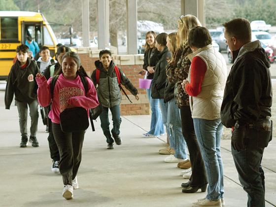 High Five Friday is a new initiative that aims to bring community members and older students in to encourage middle schoolers to have a good day.