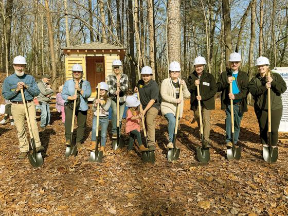 The Abercrombies and Habitat for Humanity board members break ground on the location of their new build in Ellijay.