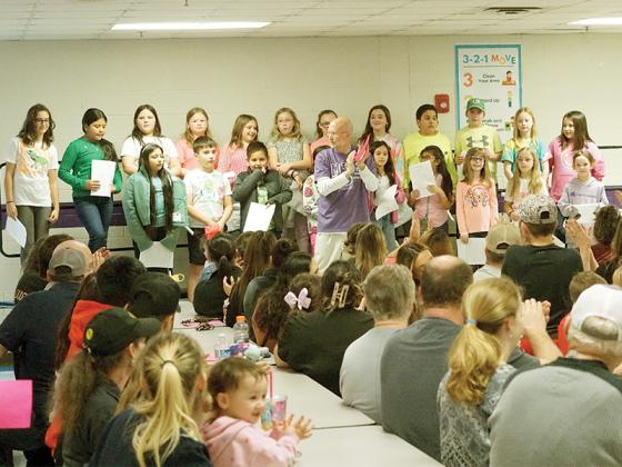 Chorus students sing rain forest-themed songs in Mountain View’s cafeteria ahead of the Glow Show.
