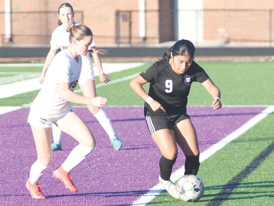 Gilmer High School’s Gimena Domingo-Tercero (9) works the ball along the boundary.