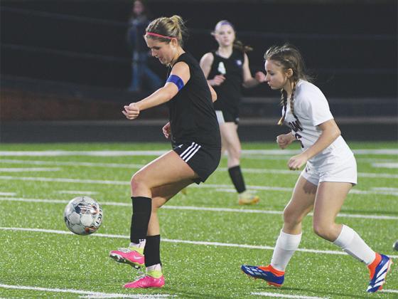 Sophia Lykins shields a Dawson County player from the ball last Friday.