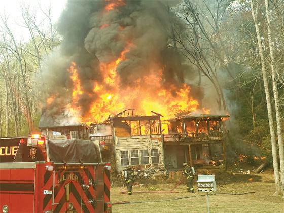 The home on McCrary Court engulfed in flames around 10 a.m. Saturday, March 8. (Photo courtesy of Jan Stewart)