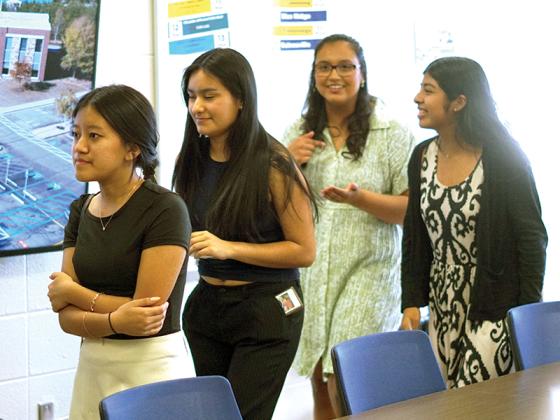 Rose Bawihnem (left), a junior at Gilmer High and a member of Upward Bound, checked out the new hub with other members of the program.