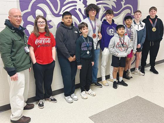 Coach Walt Monroe and Gilmer wrestlers, J.J. McArthur, Caleb Gaspar, Asher Kleczka, Jake Watson, Tryton Haley, Rony Morales, Rudy Morales,  Jasper Barr, Parker Settel
