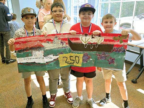 4th graders Layton James, Anthony Ruiz-Garcia, Zander Noland and Braxton Wilkie show off their winning banner that placed 3rd in the nation. (Courtesy of Misti Foster)