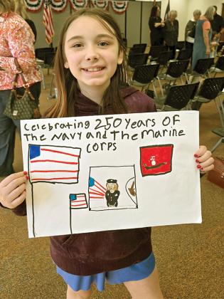 3rd grader Brooklyn Casey shows her poster that won 2nd place in the state. (Courtesy of Misti Foster)
