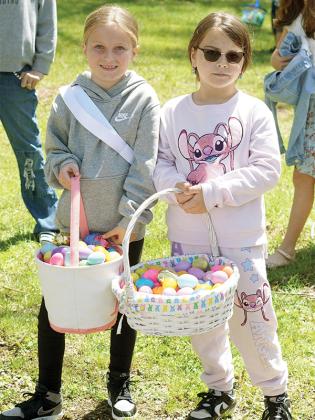 Gilmer residents Taya Mulkey and Presley Southern show off their eggs collected during the hunt.