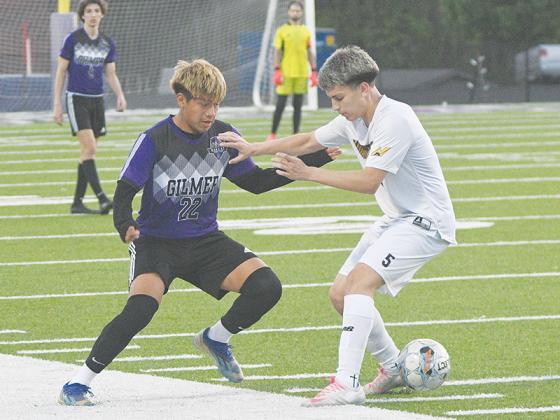 Gilmer’s Angel Garcia (22) nutmegs a Mountaineer to get loose in the midfield versus North Murray last Thursday.