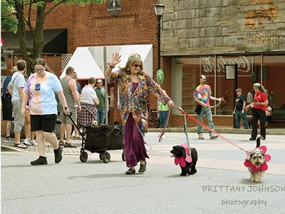 People and pets alike took it back to the 70s and dressed up in their tie-dye and fringe to walk in the parade. Other attractions at Woofstock included pet costume contests, live music, vendors, dog demonstrations, pet adoptions and more. Photographed is Ceil Thompson with her dogs Greta and Bingo. (Photographed by Brittany Johnson)