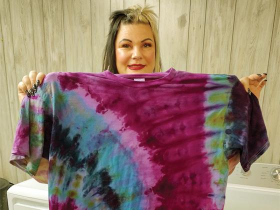 Désirée Meyer holds up a unique extra-large tie dye shirt produced by her family-oriented company, Salem Sisters Tie Dye. They make apparel that goes up to Size 6-XL. 