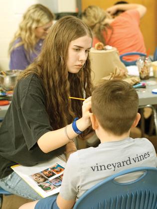 Gilmer High national art honors society students painted kids’ faces at literacy night, including 10th grader Jaiden Bauer.