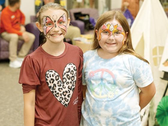 Mountain View students Laney Duggan and Leila Chron received butterfly and unicorn face paint before exploring the different booths.