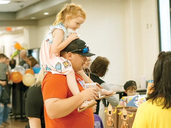 Pre-K student Maevalynn Stargell on her dad’s shoulders.