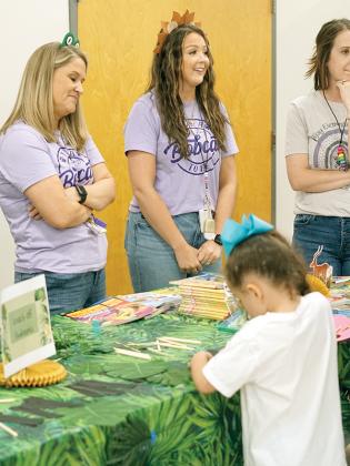 Ellijay Elementary teachers Jennifer Payne and Kelsey Davis helped attendees make bookmarks and passed out books.