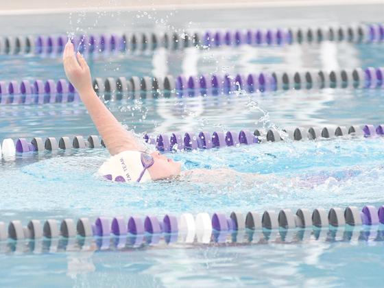 Gilmer’s Asher Faulk swims the backstroke at last Thursday’s home meet.
