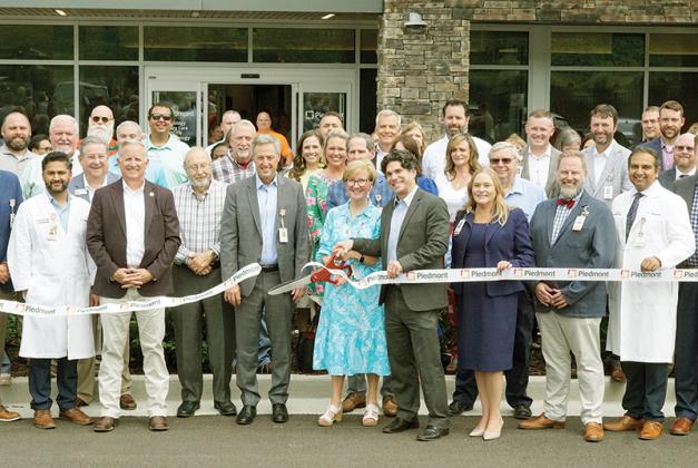 Piedmont CEO, Denise Ray, cuts the ribbon at the grand opening ceremony of the new Piedmont Healthcare facility fronting Hwy. 515 at 370 West Highlands Drive in East Ellijay. (Andy Ashurst/Publisher)