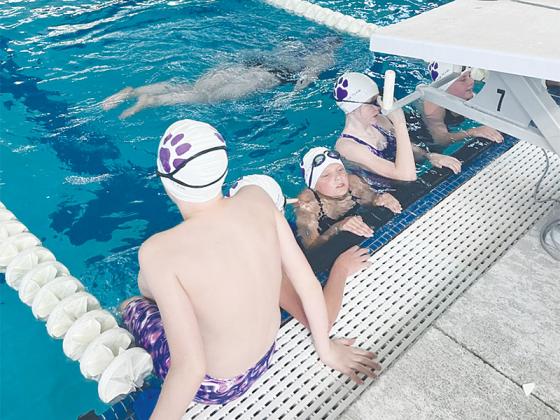 Gilmer swimmers hit the pool for warmups last Thursday at the Cherokee Aquatic Center.