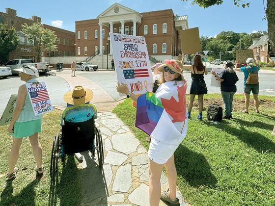 Protesters in Ellijay joined others across the country on Thursday, July 17, in honoring the late Congressman John Lewis who represented Georgia and was also a prominent leader in the civil rights movement. Bethel Spargo joined others in the Ellijay square with her placard. (Contributed photo)