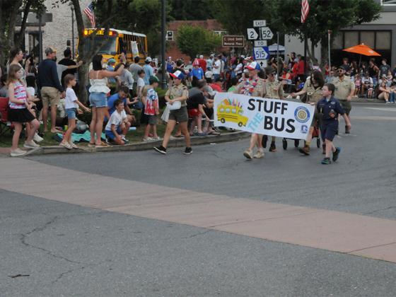 Volunteers with Stuff the Bus walk in the July Fourth parade.