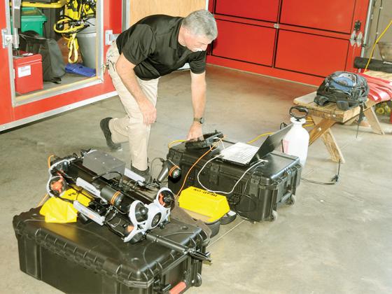 Division Chief Jeff Statham looks at the controls for Gilmer County Fire and Rescue’s new underwater drone.