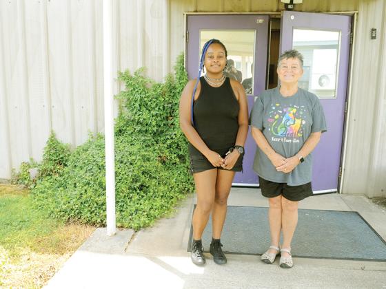Volunteers Nia Jetter, left, and Martha Heffner, right, stand outside Gilmer County Emergency Management’s Cooling Center. 
