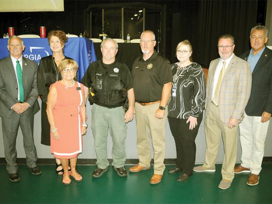 Leaders celebrate a drug court graduation and a check for nearly half a million for the Appalachian Judicial Circuit. From left, State Representative Johnny Chastain, Judge Alison Sosebee, Judge Brenda Weaver, Pickens Deputy Marc Williams, Pickens Sheriff Donald Craig, Clinician Tina Jones, Department of Behavioral Health and Developmental Disabilities Commissioner Kevin Tanner and State Senator Steve Gooch.
