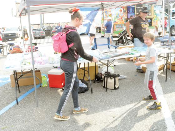 Ellyah Klein, left, and Javen Klein, right, play with their “right to bear arms” at the Ellijay market.