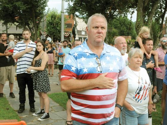 A crowd salutes the flag during the singing of the national anthem on July 4.