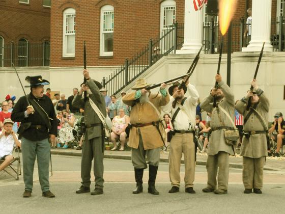 Sons of Confederate Veterans members fire a musket salute at the July 4 parade in downtown Ellijay.