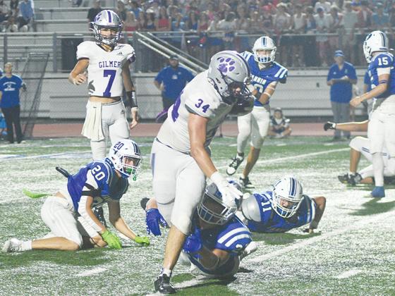 Junior Peyton Chancey leaves two Rebels in his wake as he breaks a third tackle on this way to 211 rushing yards and three touchdowns last Friday at Fannin County.