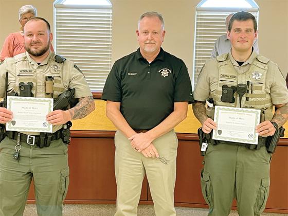 Gilmer County Deputy Blake Heptinstall (left) and Corporal Clayton Hughes (right) were honored by Gilmer County Sheriff Stacy Nicholson for their heroics actions in helping save a man whose side-by-side overturned in a swollen creek last March.