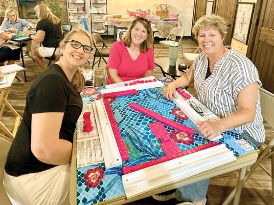 From left, Rebecca Harrell, Renee Lake and Cat Benitez play a game of mahjong together at Mahjong in the Mountains. 