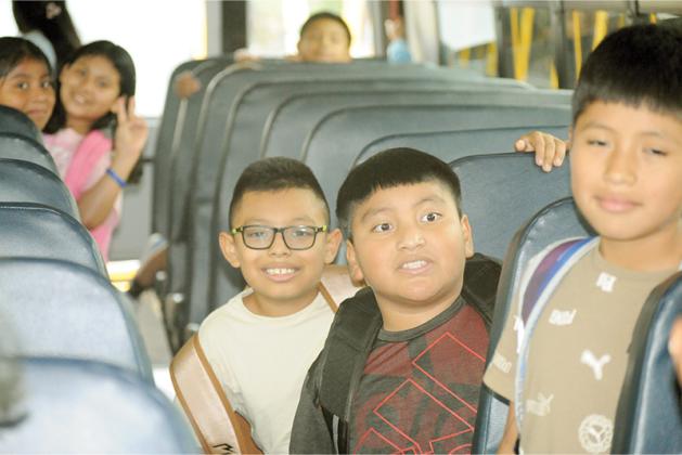 Students board the bus home from Ellijay Elementary School. Front row from left are Alberto Perez Ramirez, David Ramos Perez and Juan Raymundo Tercero.